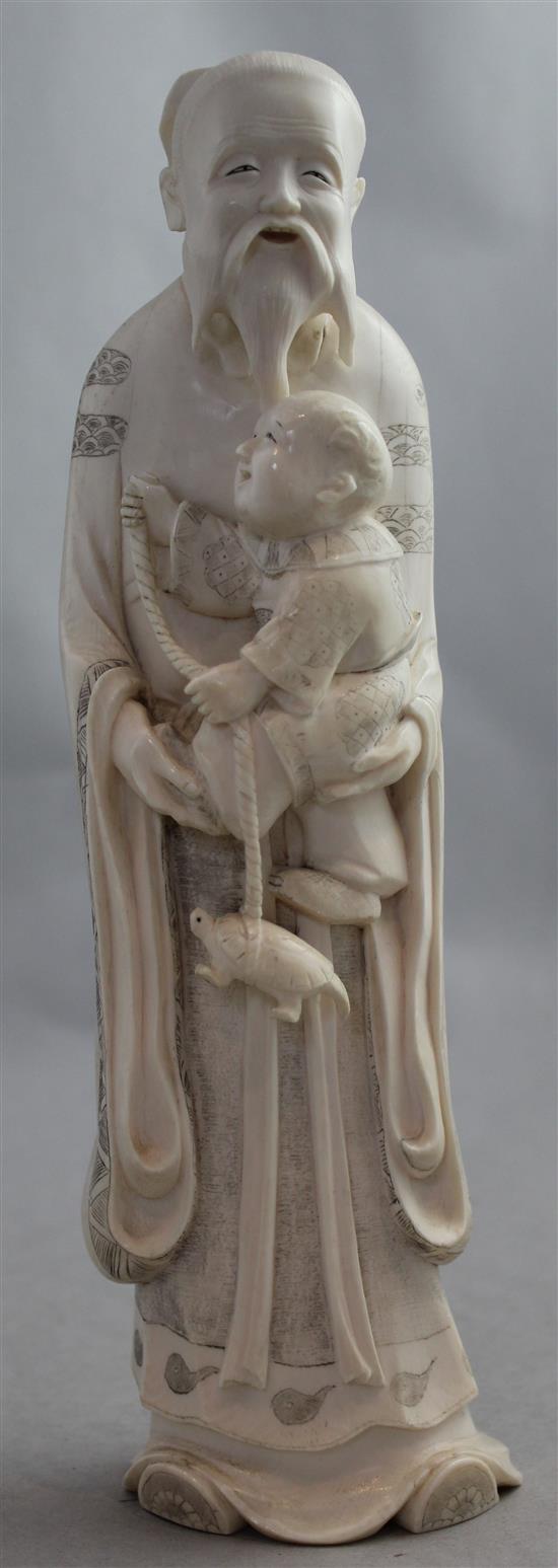 A large Japanese ivory figure of an old man holding a boy, early 20th century, 25.5cm, wood stand